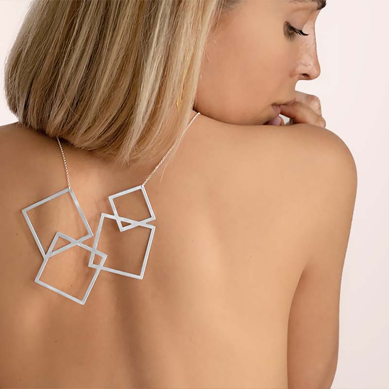 An image of a woman wearing Etherea Gallery necklace on her back